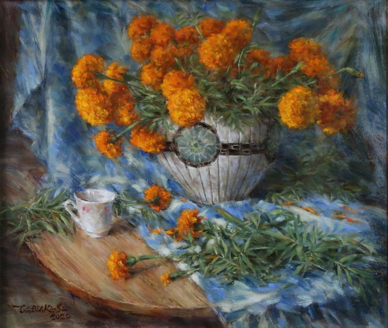 Still life of marigold flowers with a small white cup.  Feb. 2020