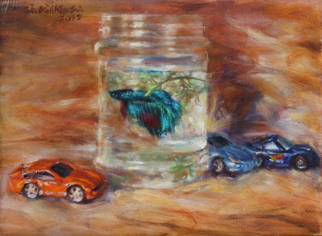 Blue betta fish and toy cars. Mar. 2017.