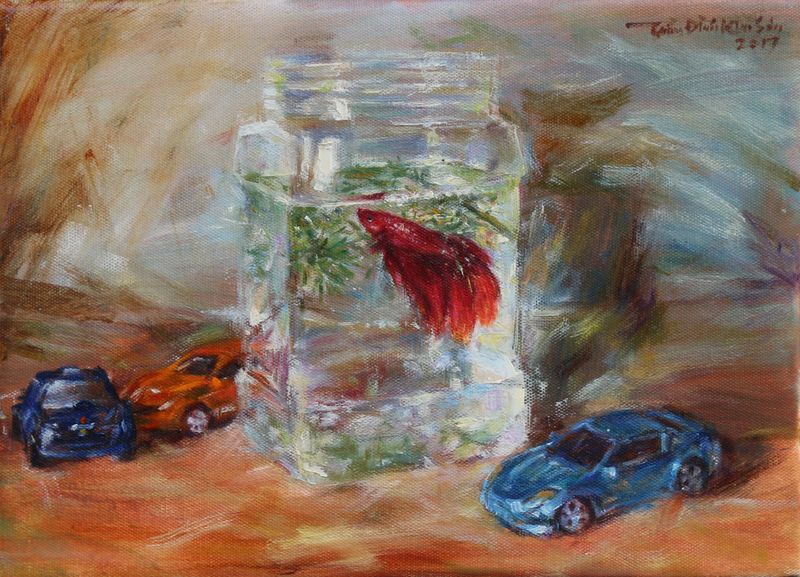 Red betta fish and toy cars. Feb. 2017.